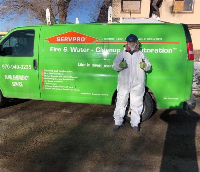 Man posing in front of a SERVPRO van