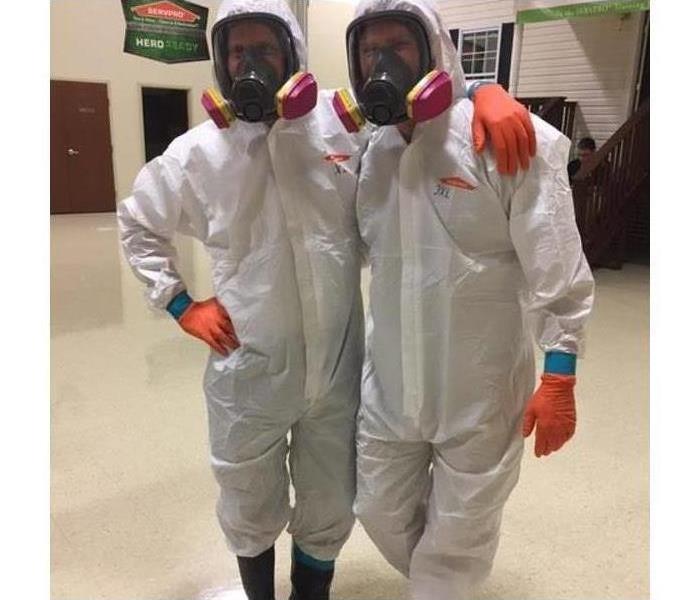 Two employees in PPE gear.